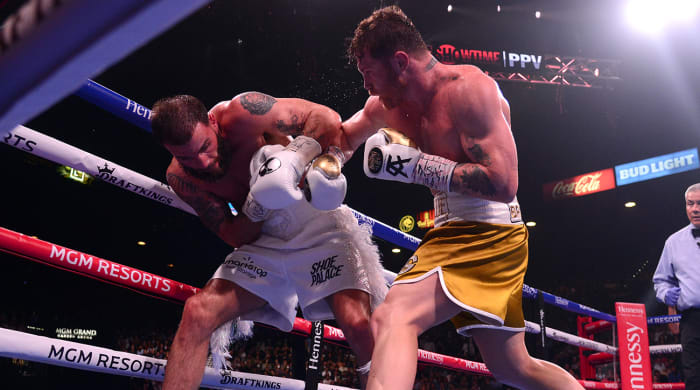 Canelo Álvarez (right) is Sports Illustrated's 2021 Fighter of the Year.